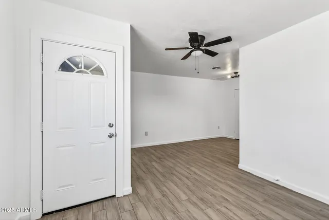 a view of a hallway with wooden floor
