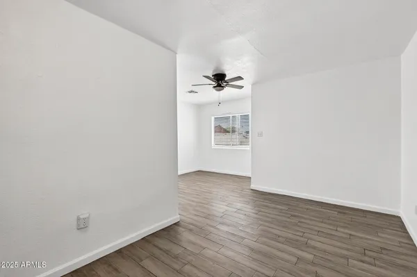 a view of a room with wooden floor