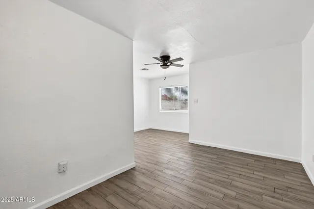 a view of a room with wooden floor