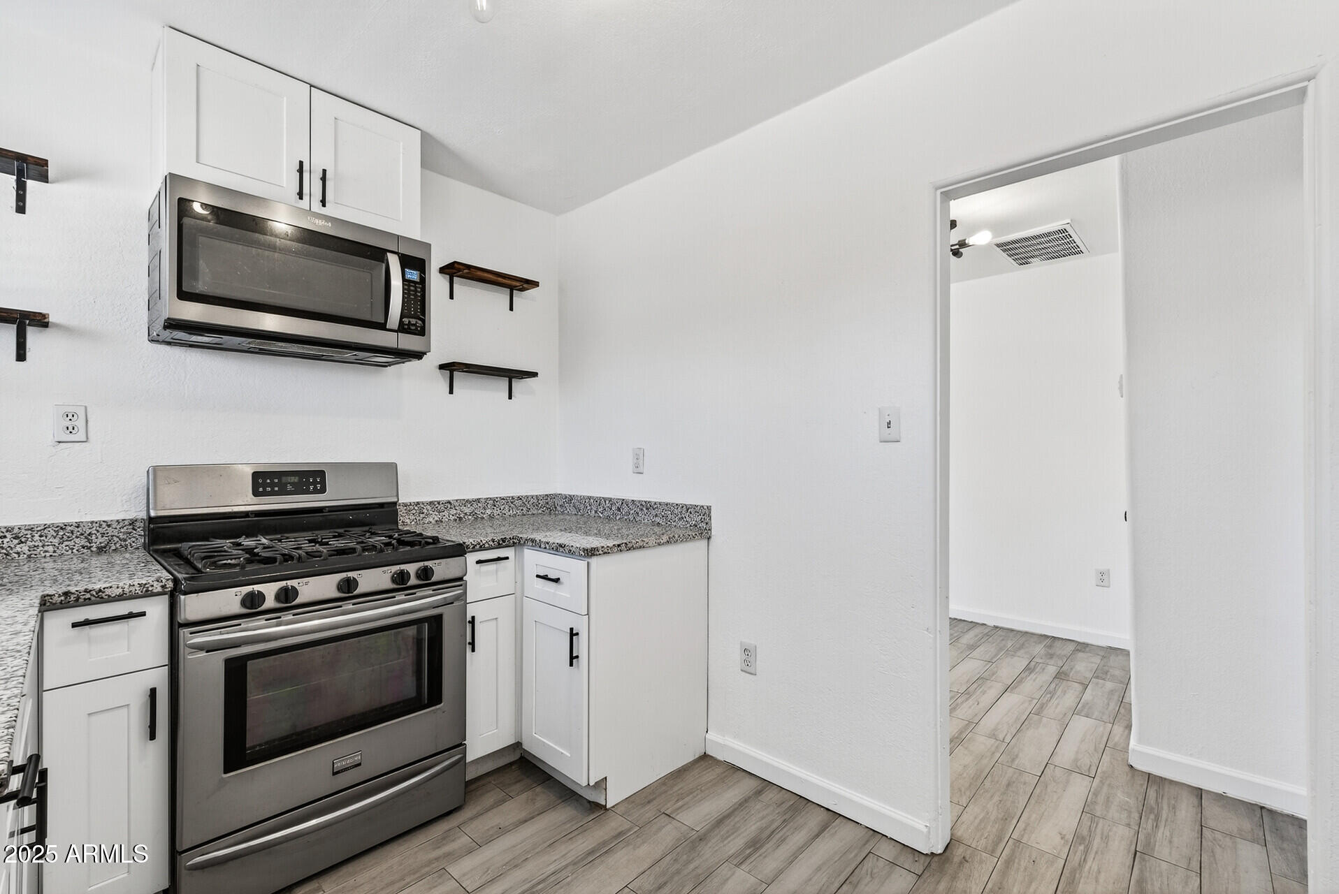107 West 11th Street Casa Grande, AZ 85122 - Photo 17 of 45 a kitchen with stainless steel appliances a stove a microwave and sink