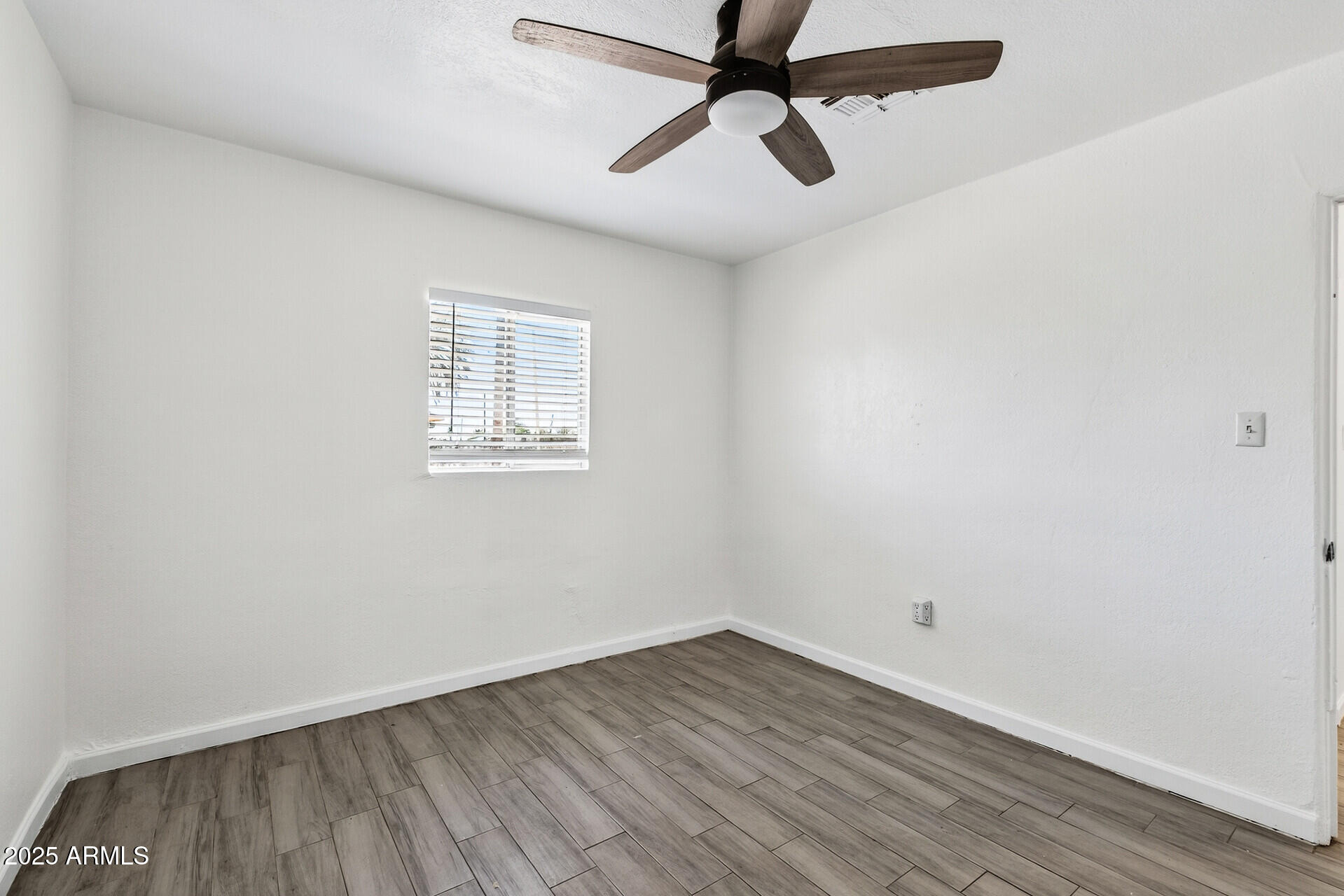 107 West 11th Street Casa Grande, AZ 85122 - Photo 19 of 45 an empty room with a window and a ceiling fan