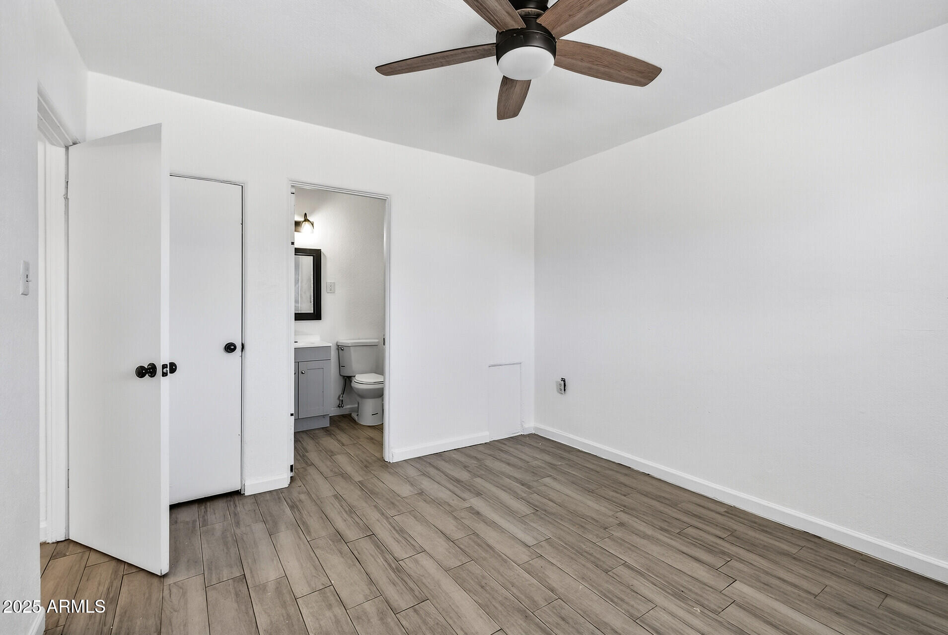 107 West 11th Street Casa Grande, AZ 85122 - Photo 21 of 45 an empty room with wooden floor and a ceiling fan