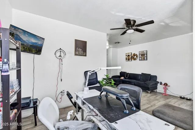 a living room with furniture and wooden floor
