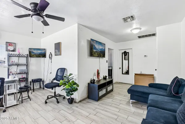 a living room with furniture and a wooden floor