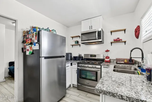 a bathroom with a sink a toilet and shower curtain