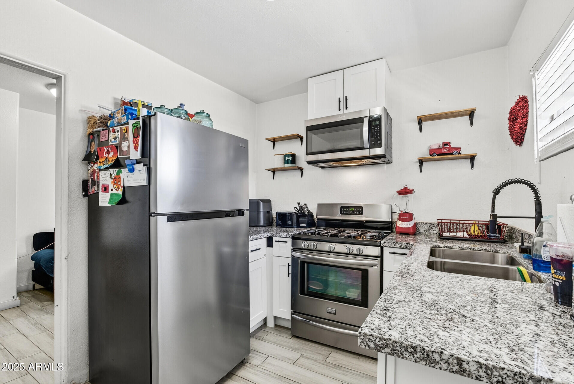 107 West 11th Street Casa Grande, AZ 85122 - Photo 31 of 45 a kitchen with stainless steel appliances granite countertop a refrigerator and a stove top oven