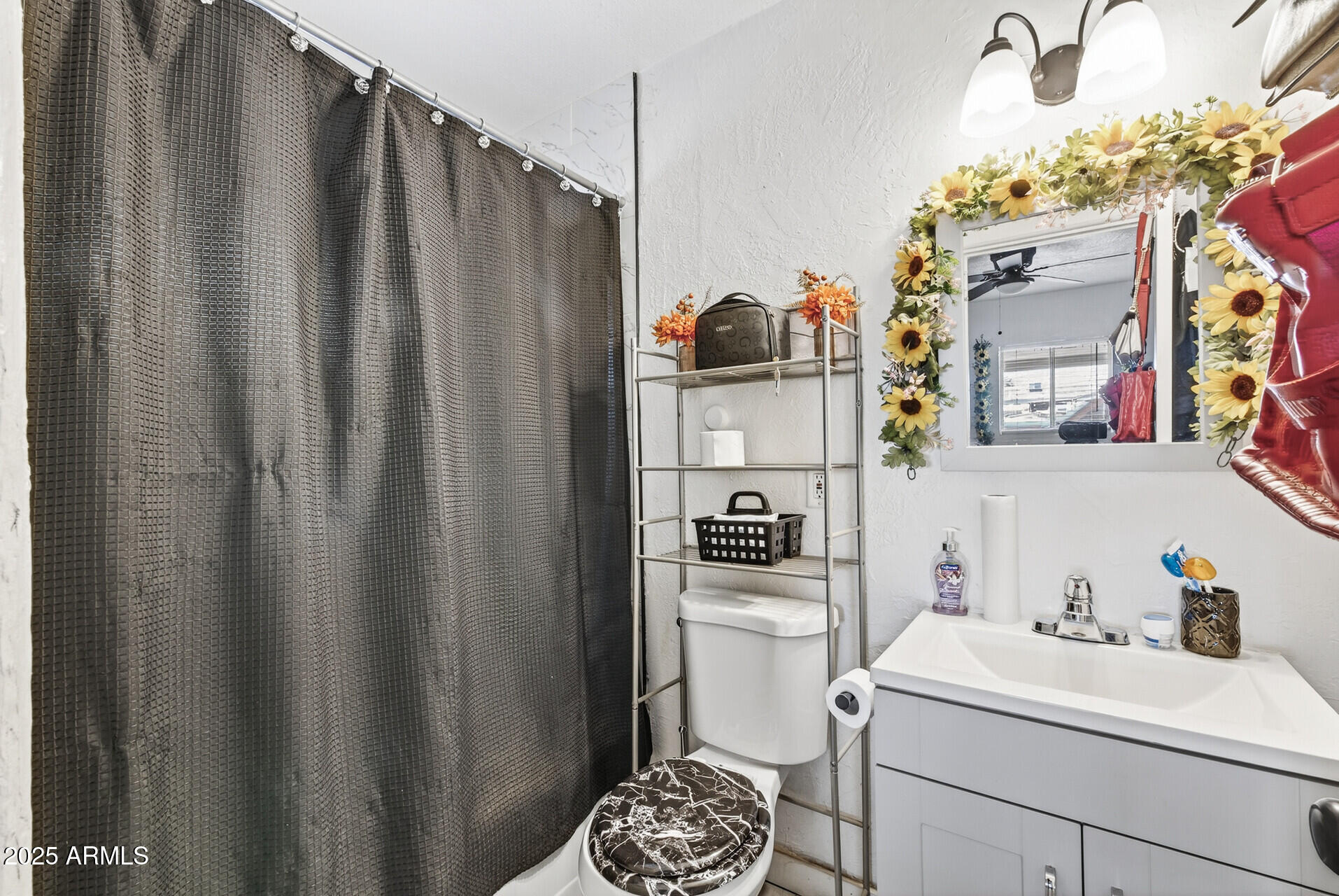 107 West 11th Street Casa Grande, AZ 85122 - Photo 32 of 45 a bathroom with a sink a toilet and shower curtain