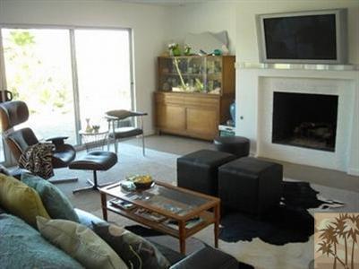 68470 Terrace Road Cathedral City, CA 92234 - Photo 4 of 17 a living room with furniture a flat screen tv and a fireplace