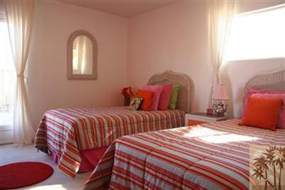 68470 Terrace Road Cathedral City, CA 92234 - Photo 10 of 17 a bedroom with two beds and a potted plant