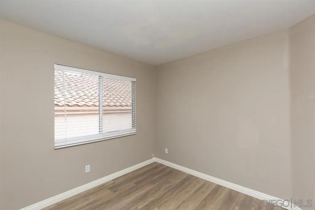 555 Kiley Road Chula Vista, CA 91910 - Photo 20 of 24 an empty room with wooden floor and a window