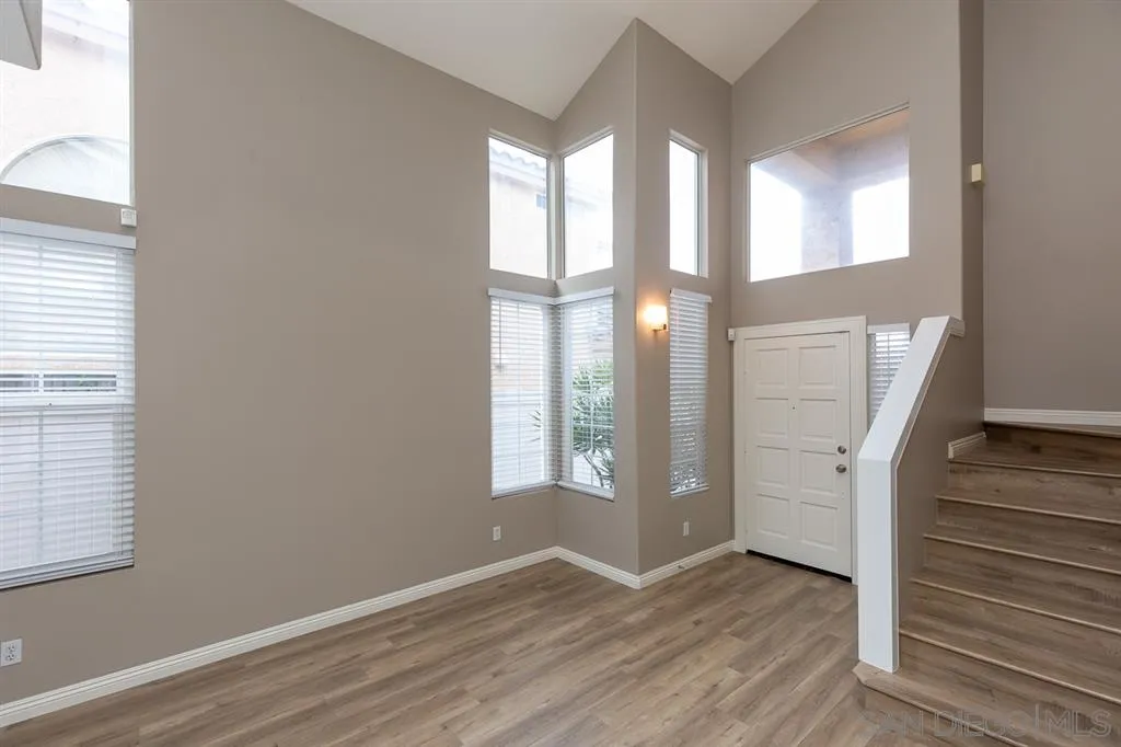 555 Kiley Road Chula Vista, CA 91910 - Photo 4 of 24 an empty room with wooden floor and windows