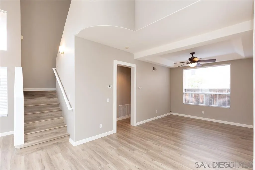 555 Kiley Road Chula Vista, CA 91910 - Photo 6 of 24 a view of an empty room with wooden floor and a window