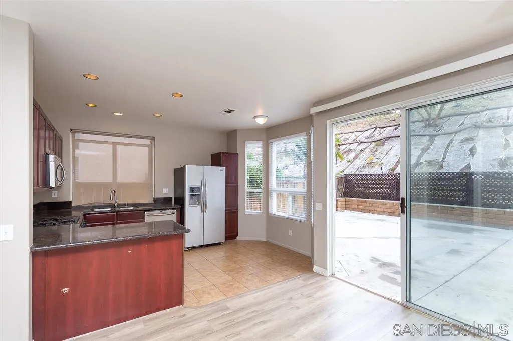 555 Kiley Road Chula Vista, CA 91910 - Photo 7 of 24 a kitchen with stainless steel appliances granite countertop a refrigerator and a stove top oven