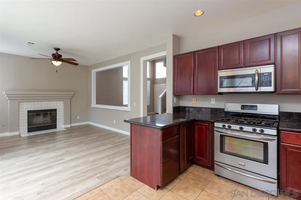 555 Kiley Road Chula Vista, CA 91910 - Photo 9 of 24 a kitchen with sink cabinets and stainless steel appliances