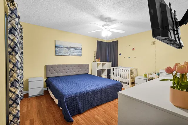 a bedroom with a large bed and a chandelier