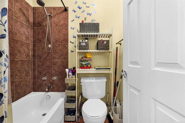 a bathroom with a toilet and a shower