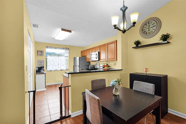 a kitchen with a table chairs and microwave