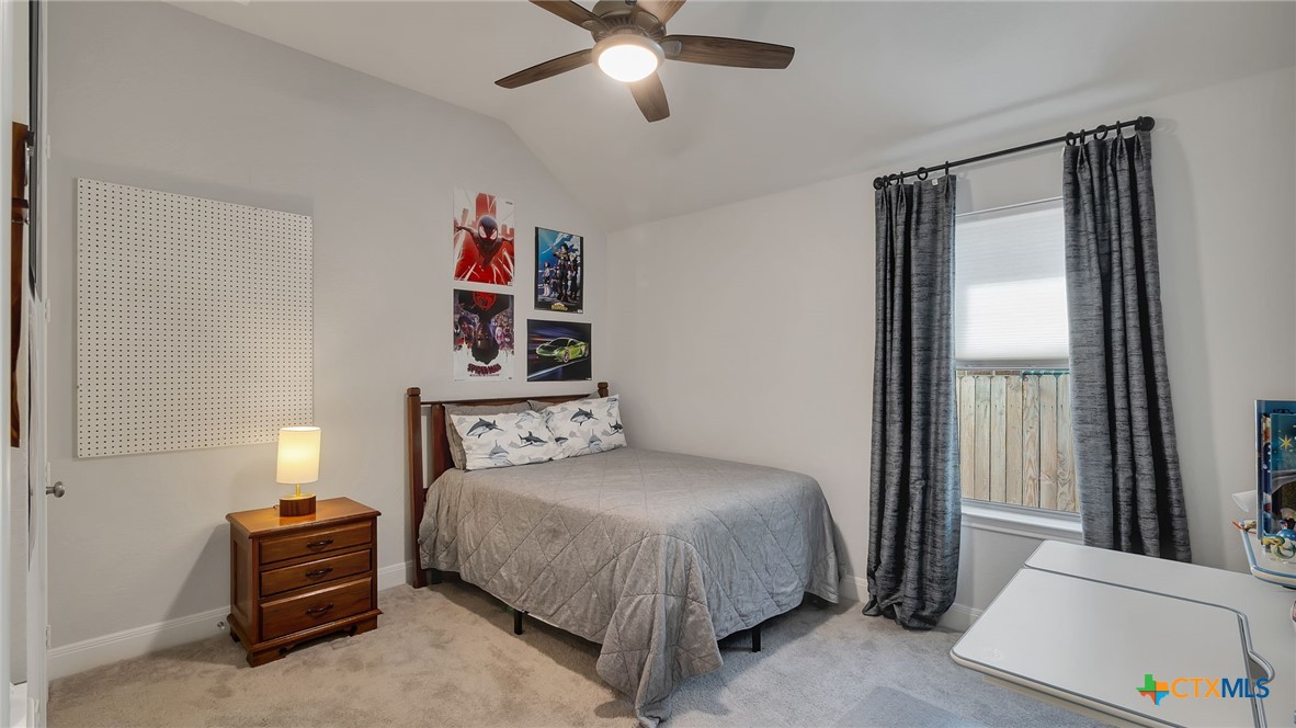 1816 Field Brook Seguin, TX 78155 - Photo 26 of 32 a bedroom with a bed and a chandelier