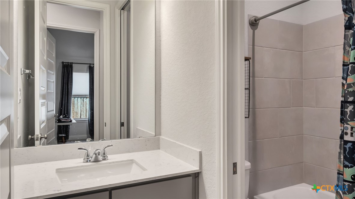1816 Field Brook Seguin, TX 78155 - Photo 27 of 32 a bathroom with a sink and a mirror