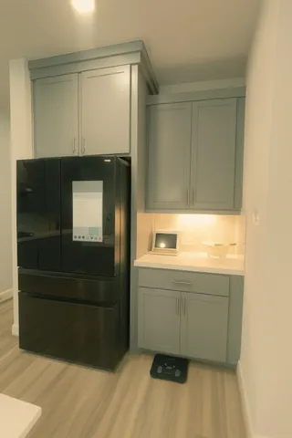 a view of hallway with stainless steel kitchen appliances