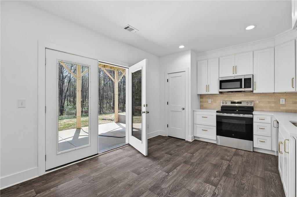 88 Carolyn Path Rockmart, GA 30153 - Photo 52 of 73 a kitchen with granite countertop a refrigerator and a stove top oven