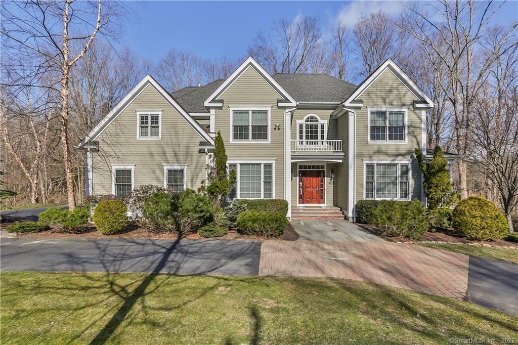 63 Great Hill Road Ridgefield, CT 06877 - Photo 1 of 1 a front view of a house with a yard and potted plants