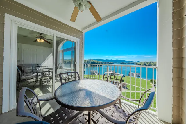 a balcony with table and chairs