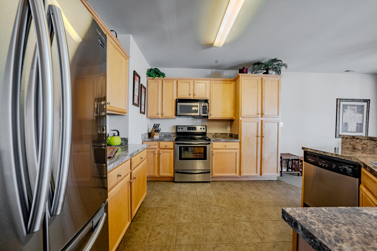 1217 Graves Harbor Trail, Unit 144 Huddleston, VA 24104 - Photo 14 of 30 a kitchen with stainless steel appliances granite countertop a refrigerator a stove and a sink