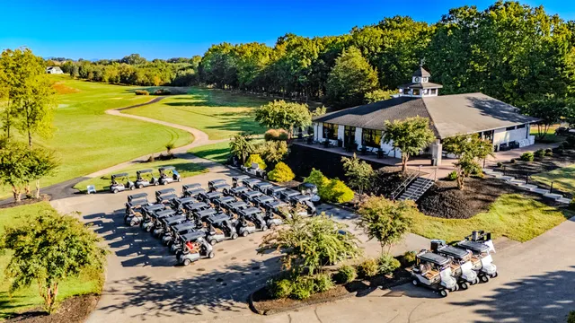 an aerial view of a house with a garden and lake view