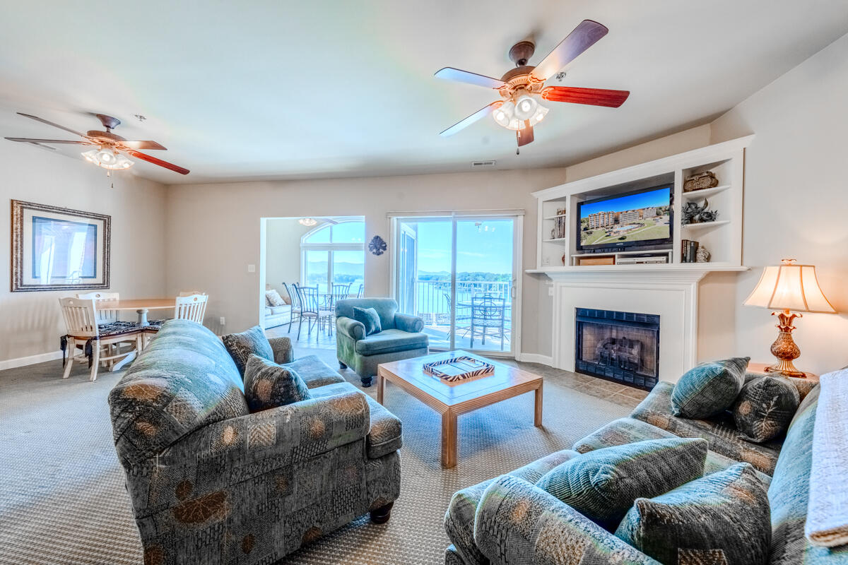 1217 Graves Harbor Trail, Unit 144 Huddleston, VA 24104 - Photo 3 of 30 a living room with furniture a fireplace and a flat screen tv