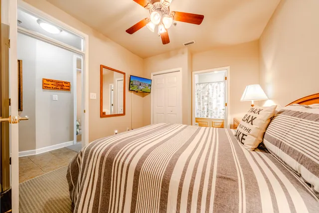 a bedroom with a bed and a chandelier