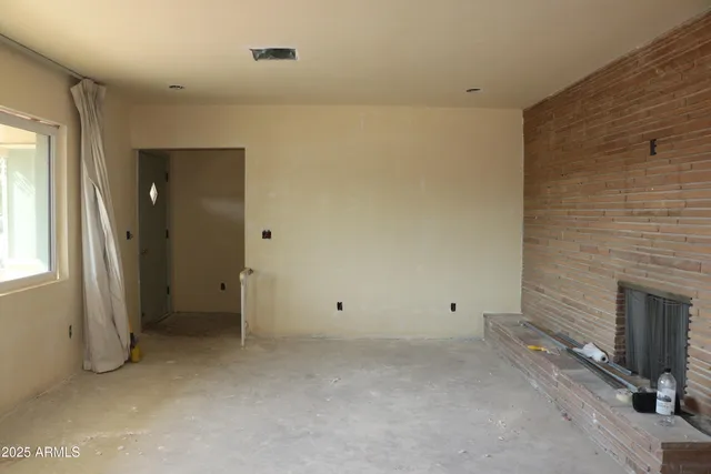 a view of an empty room with a fireplace