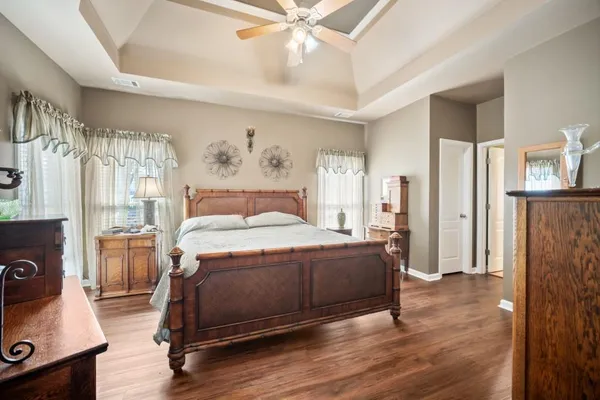 a spacious bedroom with a bed and a chandelier