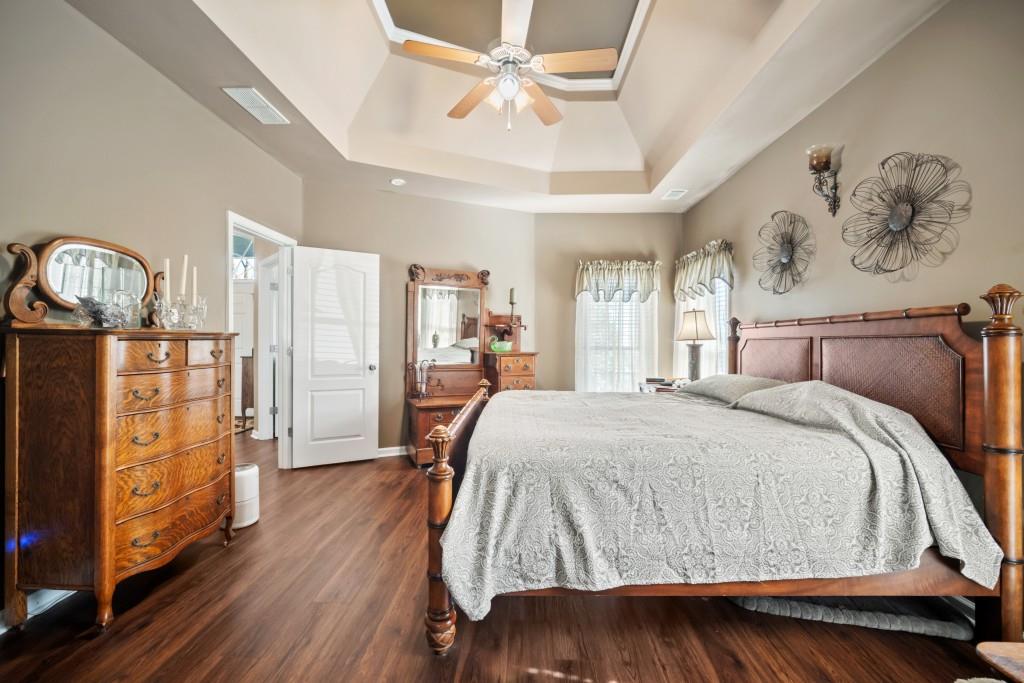 348 Mountain Laurel Walk Canton, GA 30114 - Photo 13 of 26 a spacious bedroom with a bed mirror and window