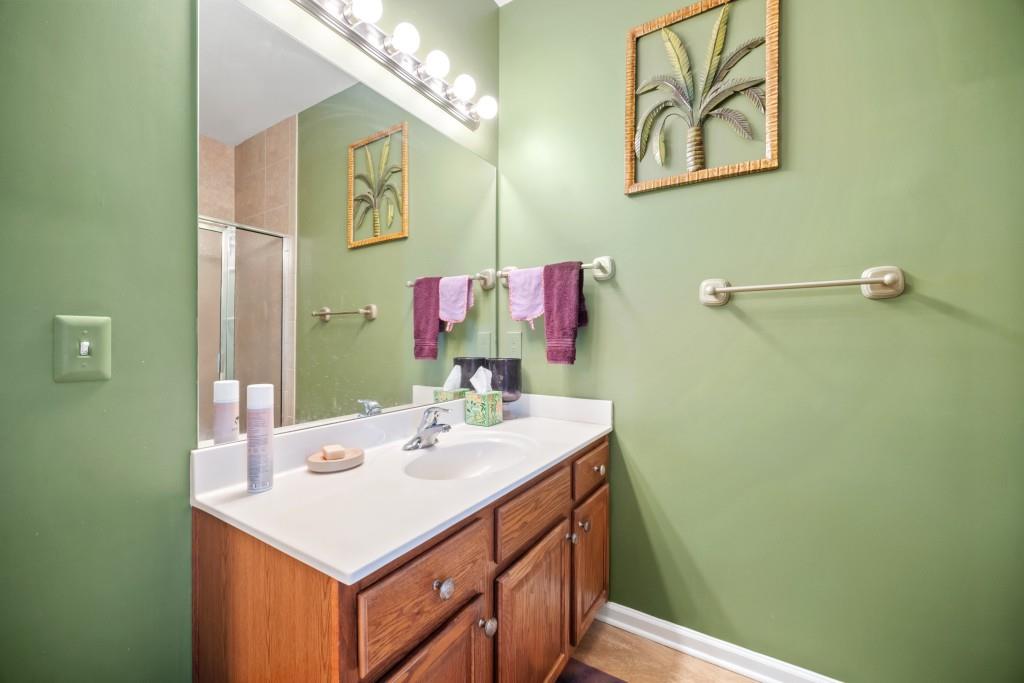 348 Mountain Laurel Walk Canton, GA 30114 - Photo 16 of 26 a bathroom with a sink vanity and a mirror