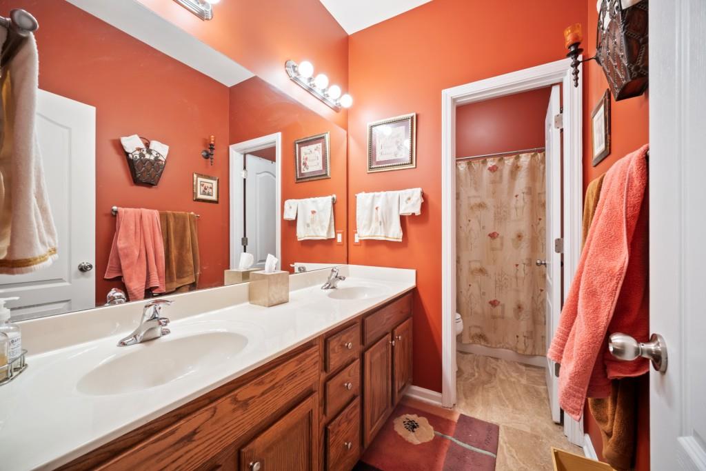 348 Mountain Laurel Walk Canton, GA 30114 - Photo 19 of 26 a bathroom with a sink and a mirror