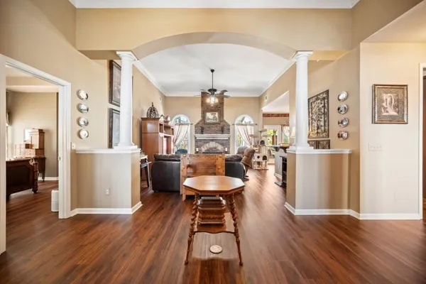 a living room with furniture and a wooden floor