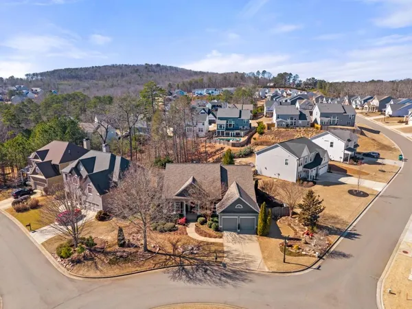 an aerial view of a house with a mountain