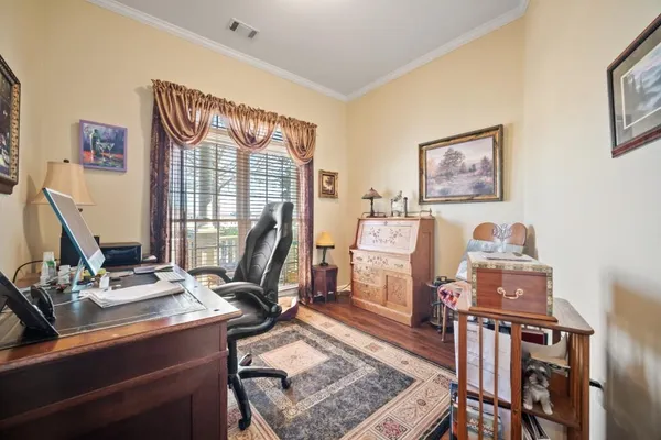 a view of a workspace with furniture and a window