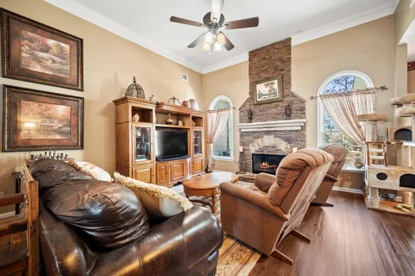 a living room with furniture a fireplace and a flat screen tv