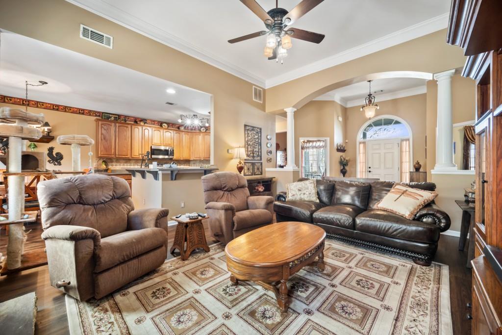 348 Mountain Laurel Walk Canton, GA 30114 - Photo 6 of 26 a living room with furniture a fireplace and a chandelier
