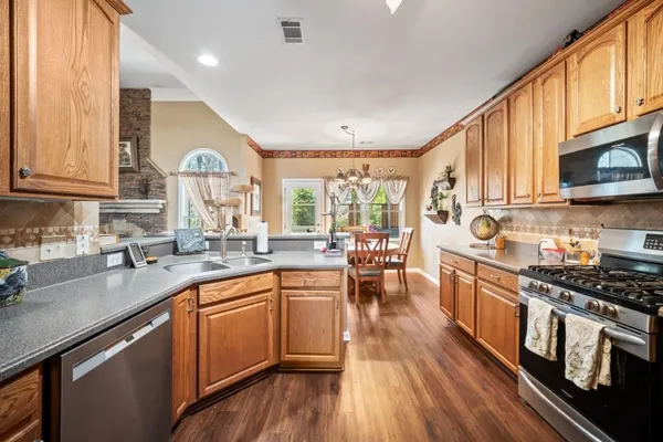 a kitchen with lots of counter top space and wooden floor