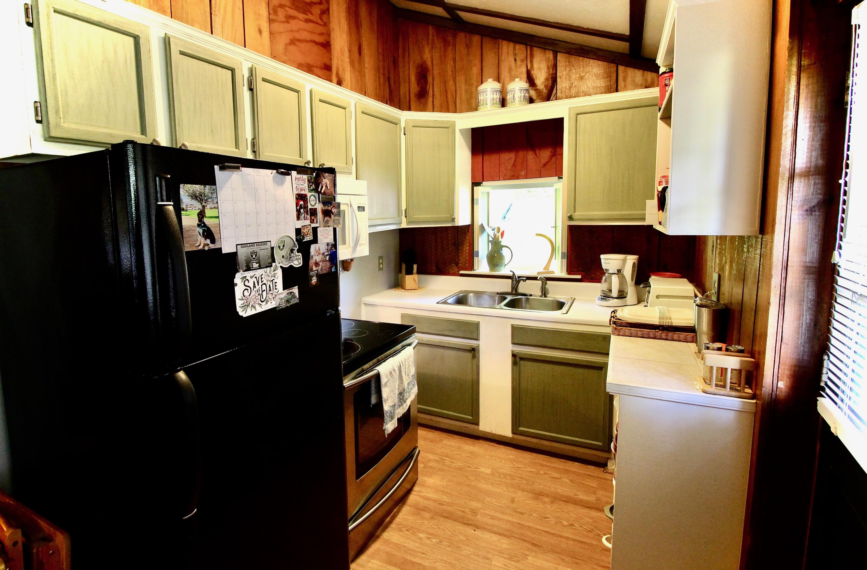4066 Daugherty Road Salem, VA 24153 - Photo 11 of 23 a kitchen with stainless steel appliances a refrigerator a sink a stove and white cabinets