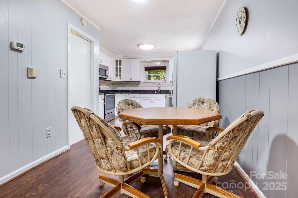 3 Stockwood Road Asheville, NC 28803 - Photo 18 of 36 a view of a dining room with furniture and wooden floor