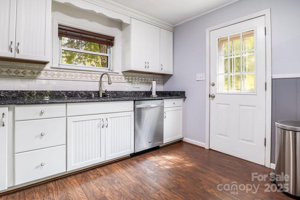 3 Stockwood Road Asheville, NC 28803 - Photo 19 of 36 a kitchen with granite countertop white cabinets and a wooden floor