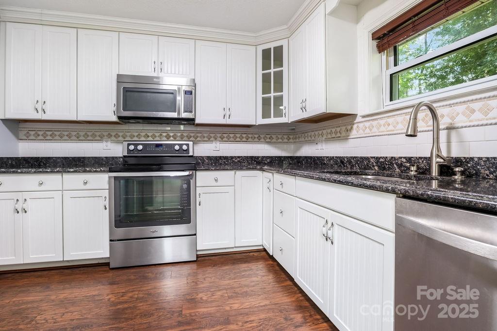 3 Stockwood Road Asheville, NC 28803 - Photo 20 of 36 a kitchen with granite countertop white cabinets and appliances