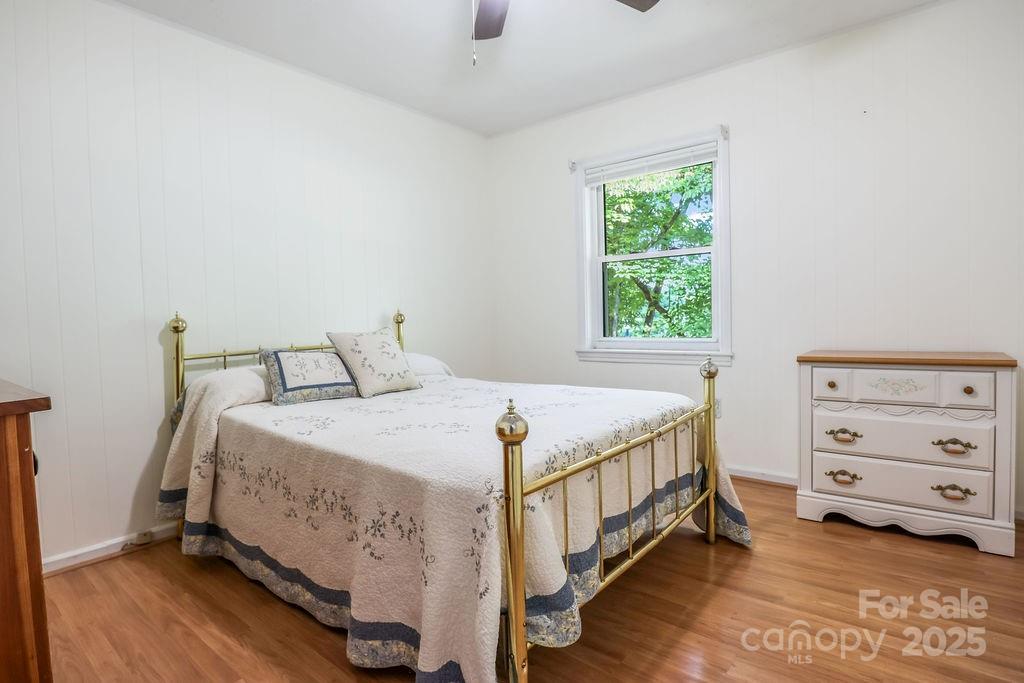 3 Stockwood Road Asheville, NC 28803 - Photo 22 of 36 a bedroom with a bed and a window