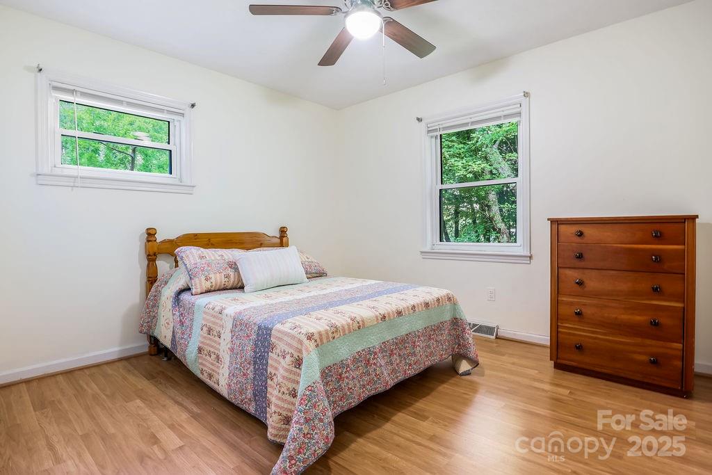 3 Stockwood Road Asheville, NC 28803 - Photo 23 of 36 a bedroom with a bed and a dresser