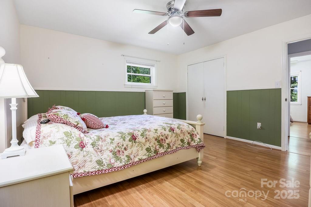 3 Stockwood Road Asheville, NC 28803 - Photo 25 of 36 a bedroom with a large bed and a chandelier