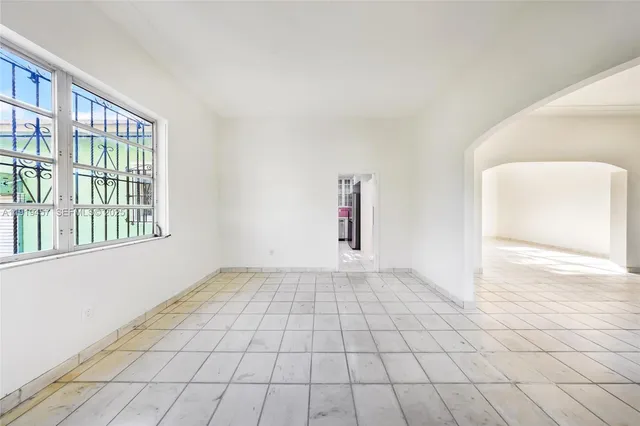 a view of a refrigerator and an empty room in a gallery